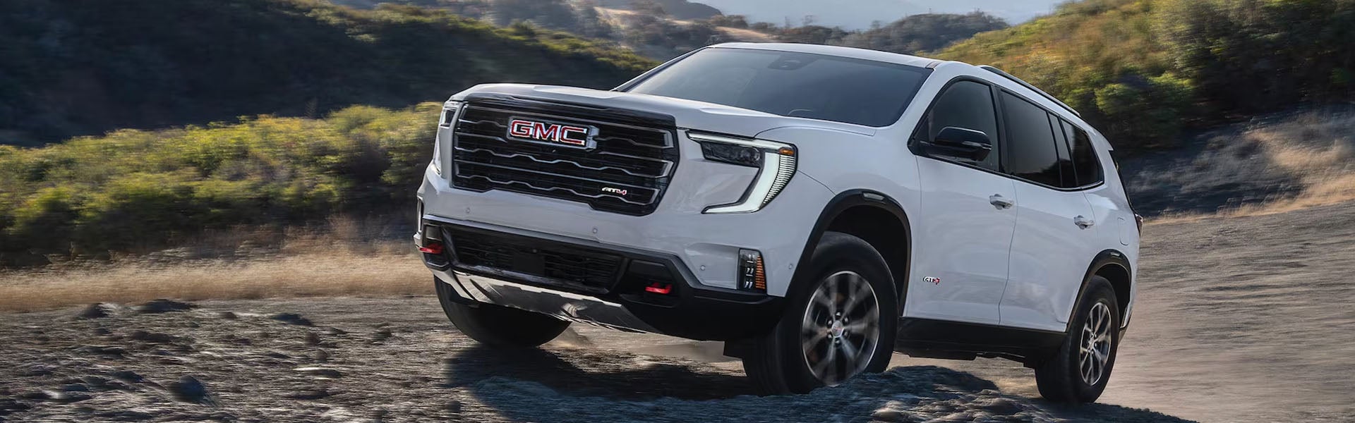 Front view of 2026 GMC Acadia off-road landscape